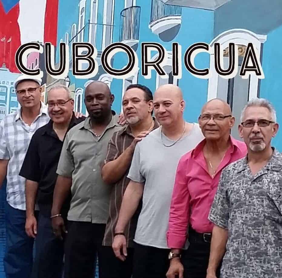 Cuboricua band in front of a colorful wall.