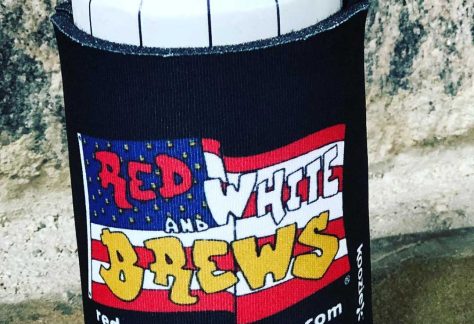 A can of beer with a Red White and Brews koozie