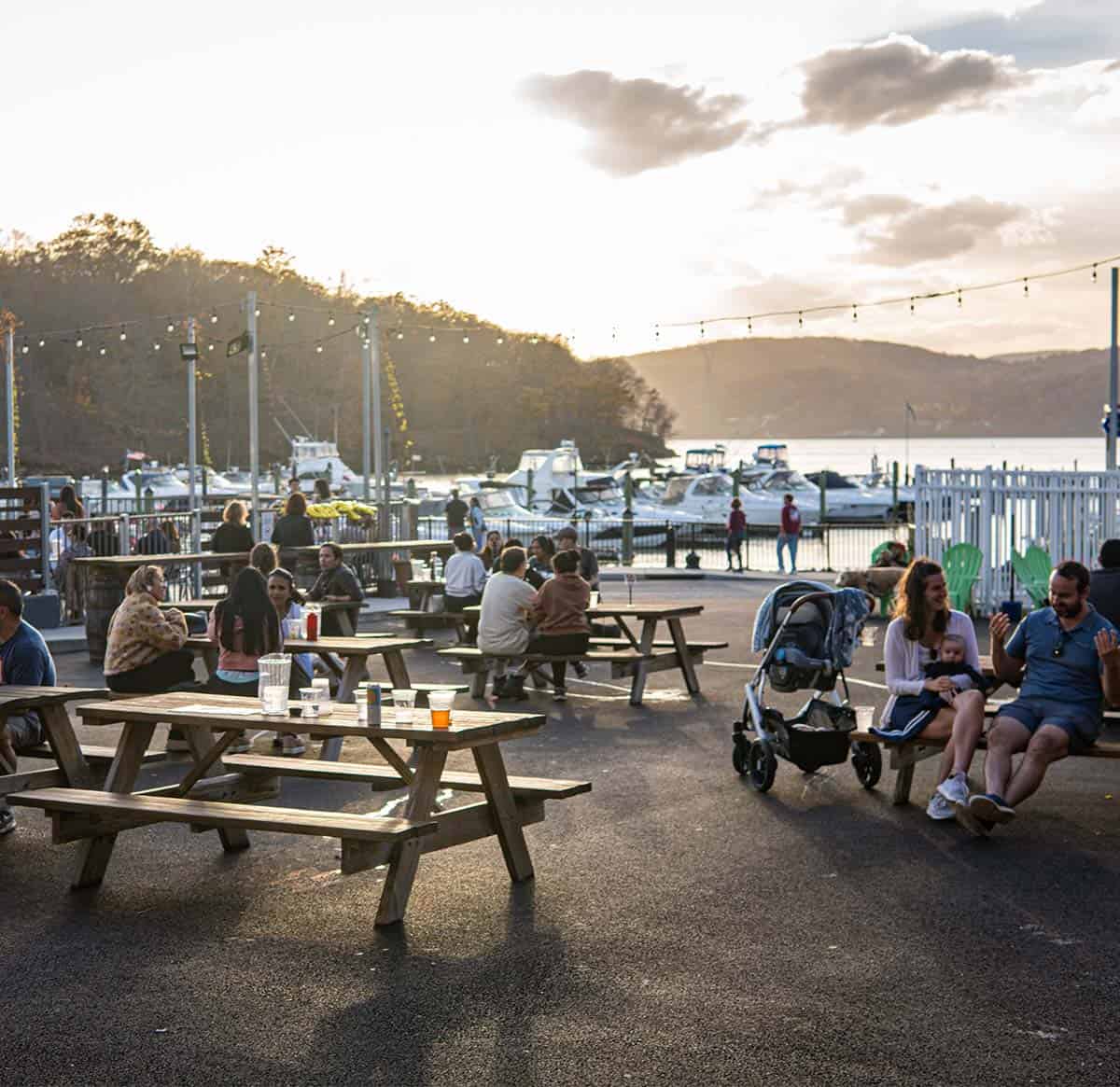 The sunsets over the picnic table dining area at River Outpost Brewing Co. in Peekskill, NY