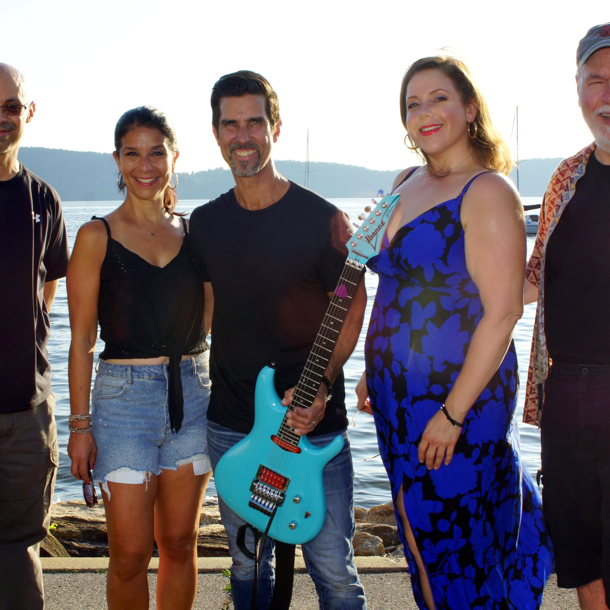 The Mike Risko Band posing in front of the river on a beautiful day.
