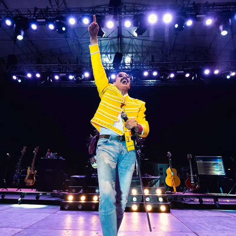 Joseph Russo from Almost Queen as Freddie Mercury dressed in yellow.