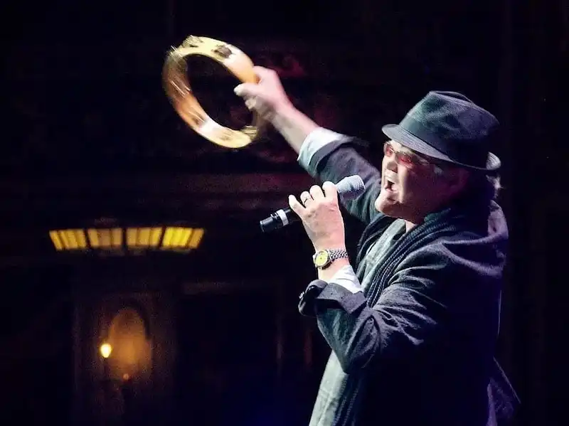 Micky Dolenz on stage with a tambourine