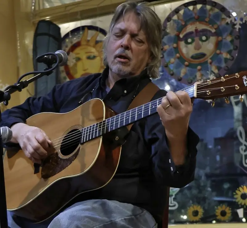 Mike Burns playing guitar at BeanRunner Cafe