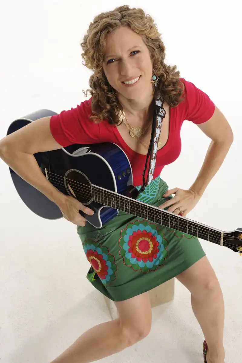 Promotion photo of Laurie Berkner with an acoustic guitar